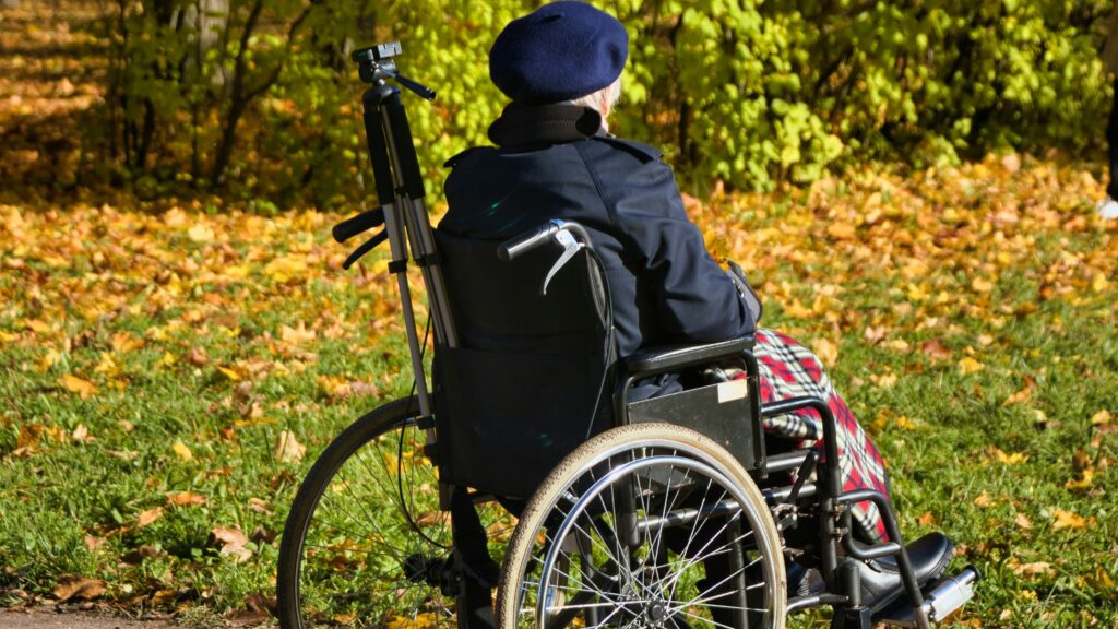 Elderly woman in wheelchair outdoors Unsplash
