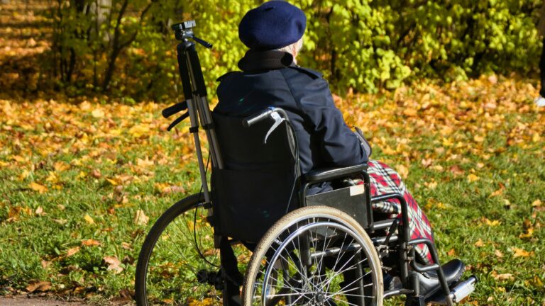 Elderly woman in wheelchair outdoors Unsplash