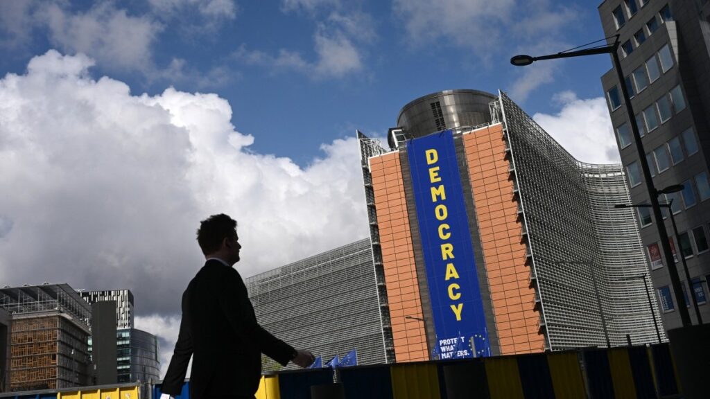 A pedestrian walks past the Berlaymont building, headquarters of the European Commission, in Brussels on April 20, 2026.