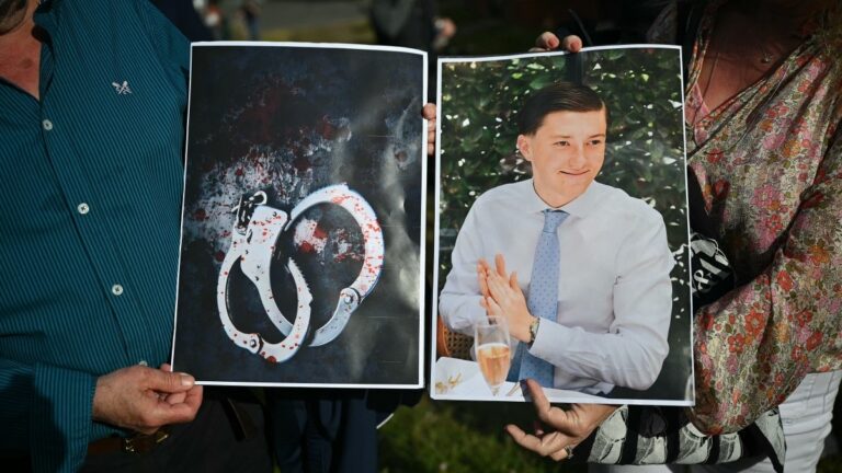 Protesters hold images of Henry Nowak and his blood-stained handcuffs outside of the Southampton police station on June 2, 2026.