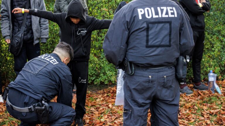 Officers of the German Federal Police (Bundespolizei) check a migrant near Forst, eastern Germany on October 11, 2023, during a patrol near the border with Poland.