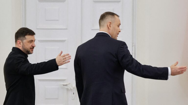 Poland’s President Karol Nawrocki (R) and Ukraine’s President Volodymyr Zelensky react at the end of a joint press conference following their talks at the Presidential Palace in Warsaw, Poland, on December 19, 2025.