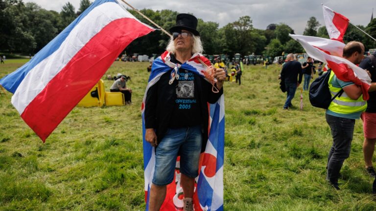 A demonstrator holds a Dutch flag during a demonstration called by the Farmers Defence Force to protest against European regulations, in Brussels, on June 4, 2024.