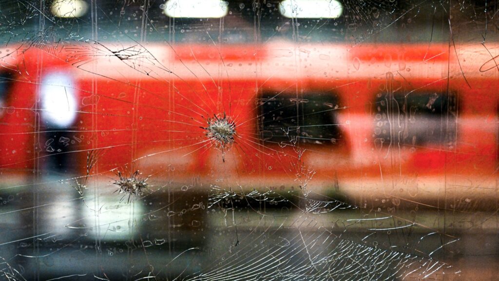 This photo taken on October 8, 2024 at the main railway station in Münster, Western Germany, shows holes in a window of an ICE high speed train of German railway operator Deutsche Bahn after stones were hurled at it.