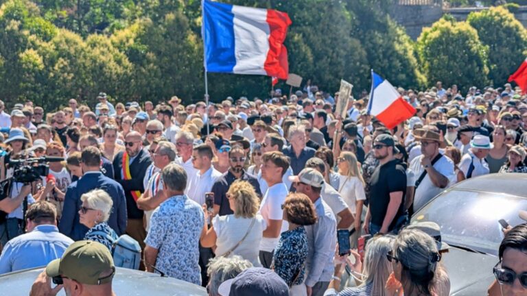 Attendees hold a banner depicting a portrait of Louis, a teenager killed in an ambush, during a tribute march to the 17 year-old boy in Narbonne, southerm France on July 5, 2026.