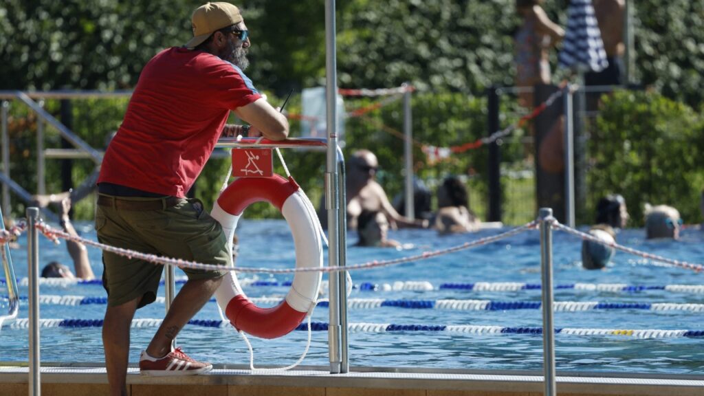 A lifeguard surveys bathers in a public swimming pool on July 2, 2025 in Berlin.