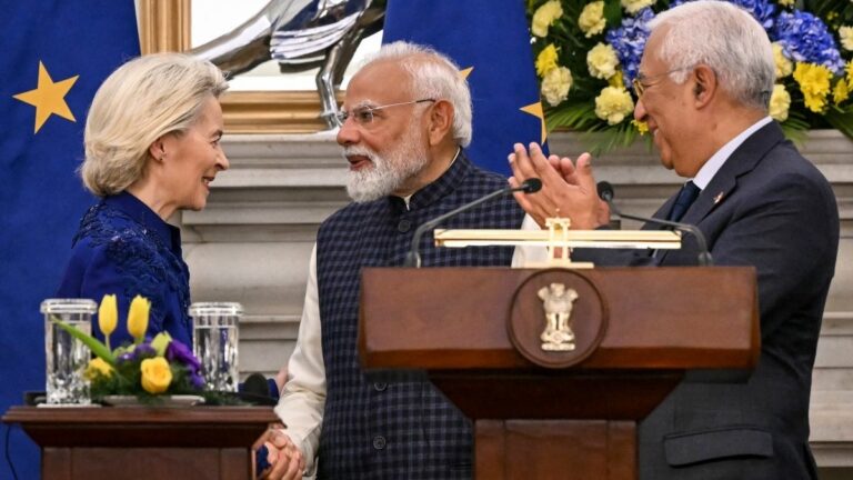 European Commission President Ursula von der Leyen (L) shakes hands with India's Prime Minister Narendra Modi (C) as European Council President António Costa watches during joint press statements after their meeting at the Hyderabad House in New Delhi on January 27, 2026.