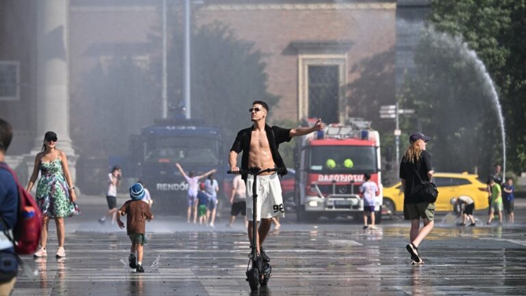 Police use water cannon to cool down people in Budapest's Heroes' Square during an extreme heat wave on June 30, 2026.