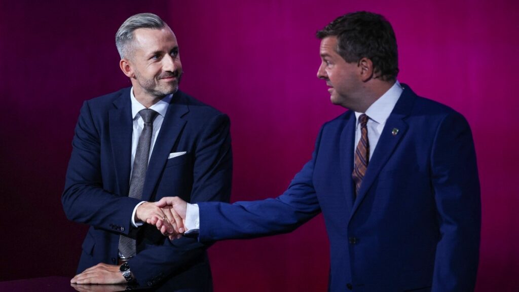 AfD lead candidate Ulrich Siegmund (L) and CDU lead candidate Sven Schulze shake hand at the start of a debate on MDR regional TV in the Broadcasting Center Saxony-Anhalt in Magdeburg, on August 26, 2026, ahead of the upcoming state elections.