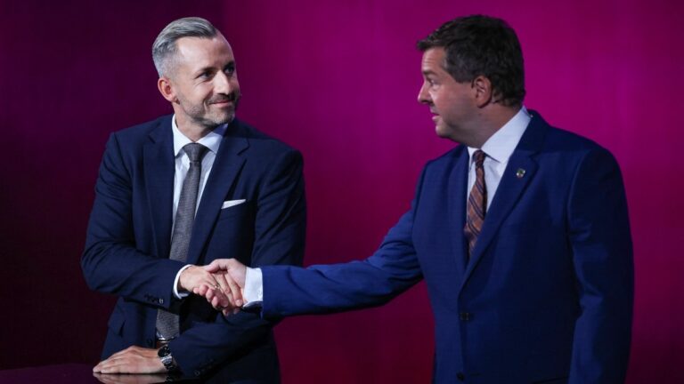 AfD lead candidate Ulrich Siegmund (L) and CDU lead candidate Sven Schulze shake hand at the start of a debate on MDR regional TV in the Broadcasting Center Saxony-Anhalt in Magdeburg, on August 26, 2026, ahead of the upcoming state elections.