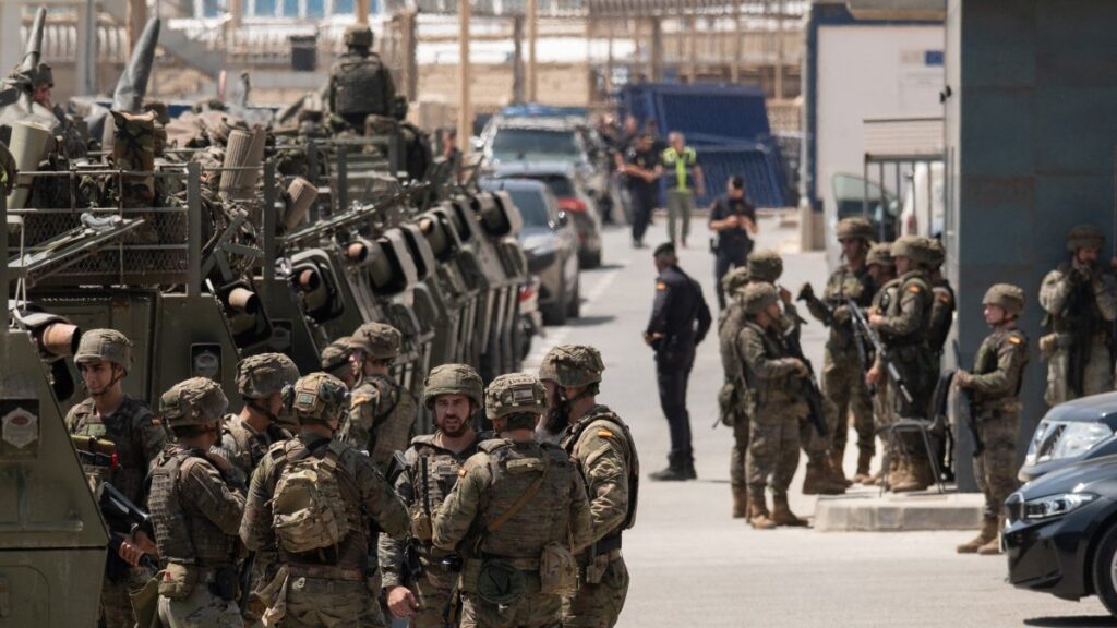 Spanish soldiers and tanks are pictured at the border fence between Morocco and the Spanish North African enclave of Ceuta on August 15, 2026.