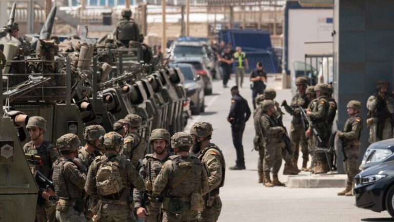 Spanish soldiers and tanks are pictured at the border fence between Morocco and the Spanish North African enclave of Ceuta on August 15, 2026.