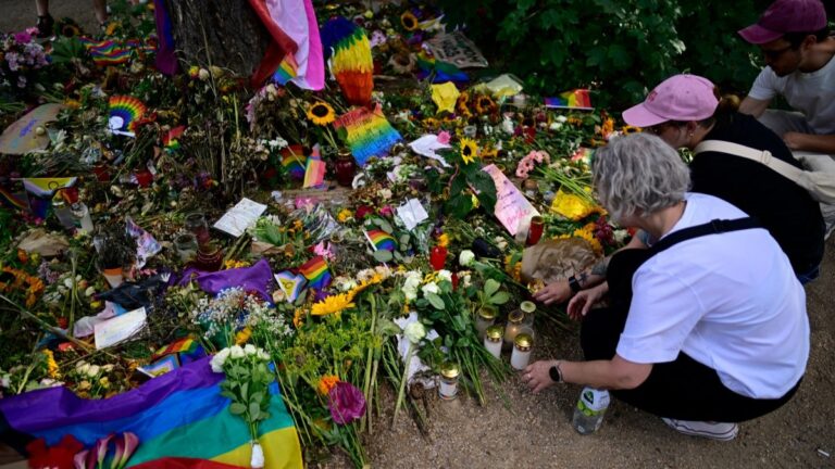 People lay flowers at a makeshift memorial in tribute to the victims at the Tiergarten park in Berlin on August 2, 2026, after an Islamist rammed his van into the crowd near the Christopher Street Day (CSD) parade on July 26, 2026.